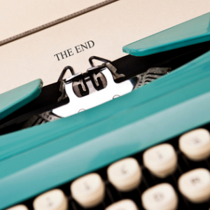 Turquoise typewriter with the words The End
