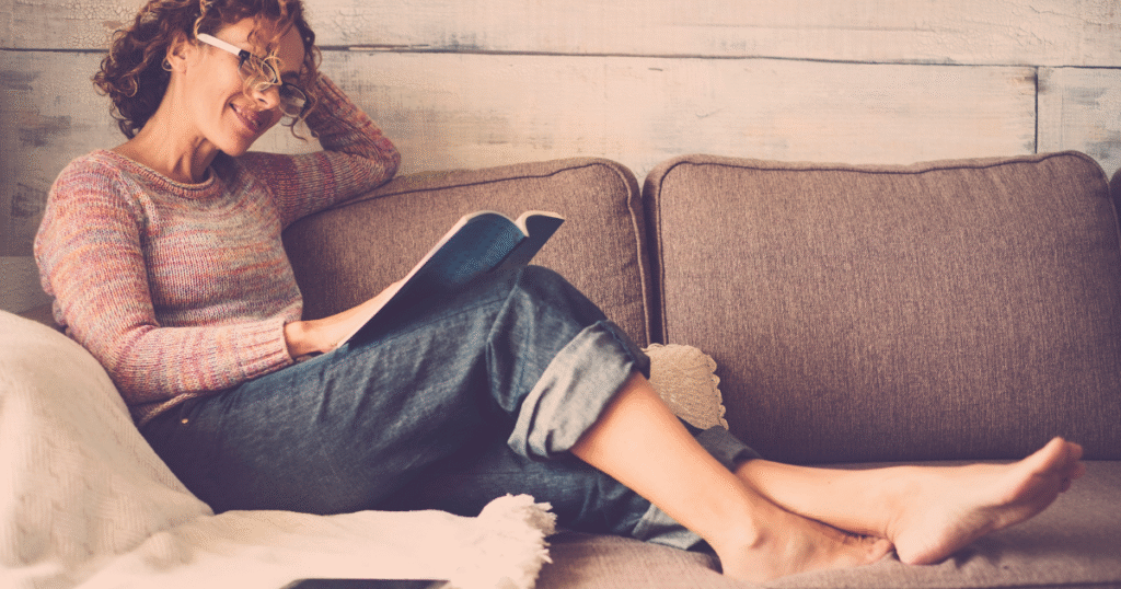 Reader enjoying a paperback book, highlighting the tactile experience and physical appeal of print books for self-published authors.